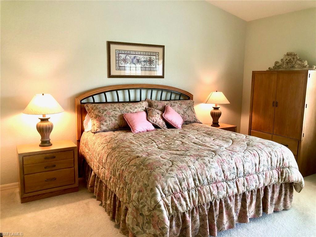 6879 Redbay Park Road, Unit 203 Naples, FL 34109 - Photo 12 of 34 a bedroom with a bed and a window