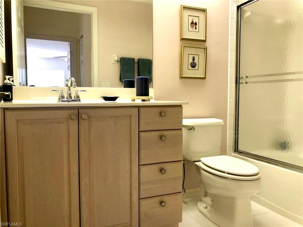 6879 Redbay Park Road, Unit 203 Naples, FL 34109 - Photo 15 of 34 a bathroom with a sink a toilet and shower