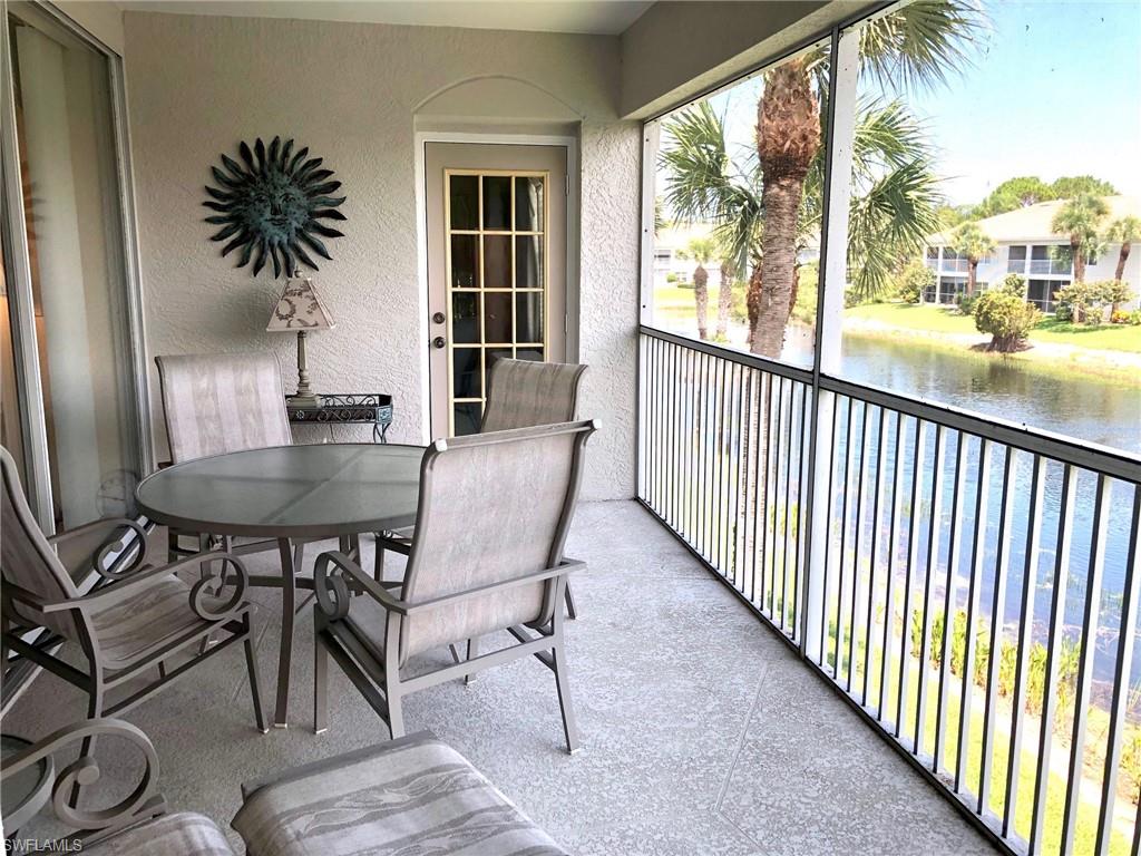 6879 Redbay Park Road, Unit 203 Naples, FL 34109 - Photo 18 of 34 a dining room with furniture window and wooden floor