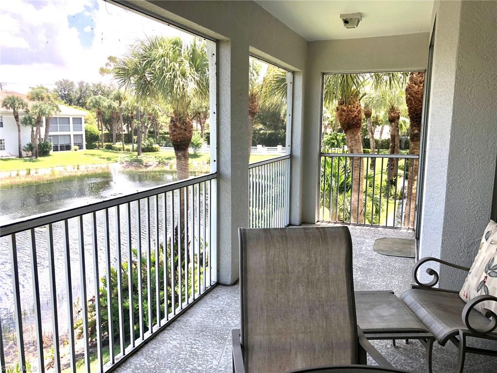 6879 Redbay Park Road, Unit 203 Naples, FL 34109 - Photo 19 of 34 a view of a living room and a floor to ceiling window