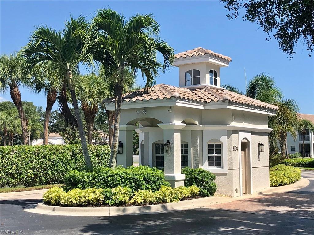 6879 Redbay Park Road, Unit 203 Naples, FL 34109 - Photo 22 of 34 front view of house with a garden