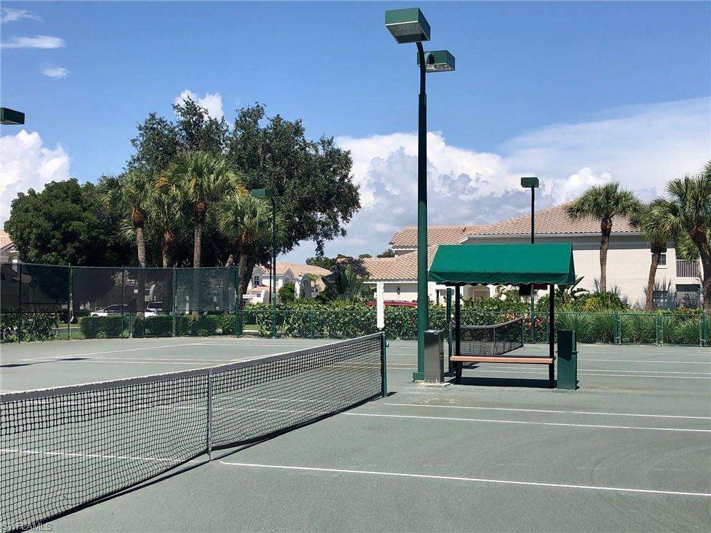 6879 Redbay Park Road, Unit 203 Naples, FL 34109 - Photo 24 of 34 a view of a street with a building in the background