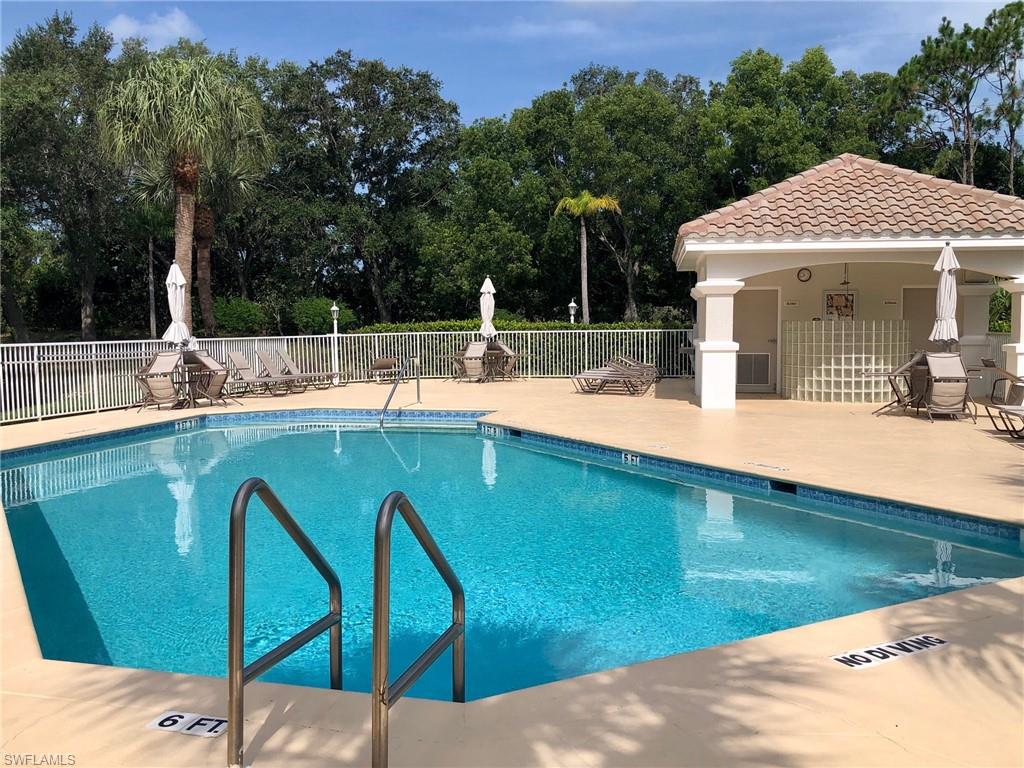 6879 Redbay Park Road, Unit 203 Naples, FL 34109 - Photo 27 of 34 a view of a patio with swimming pool