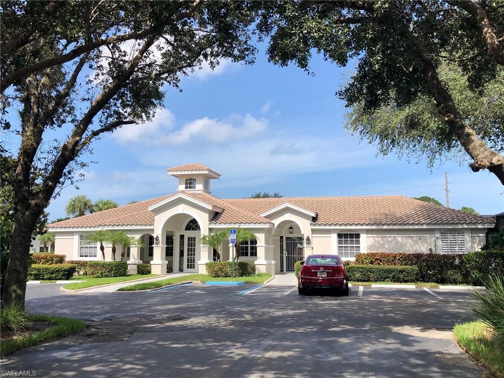 6879 Redbay Park Road, Unit 203 Naples, FL 34109 - Photo 29 of 34 a front view of a house with a garden