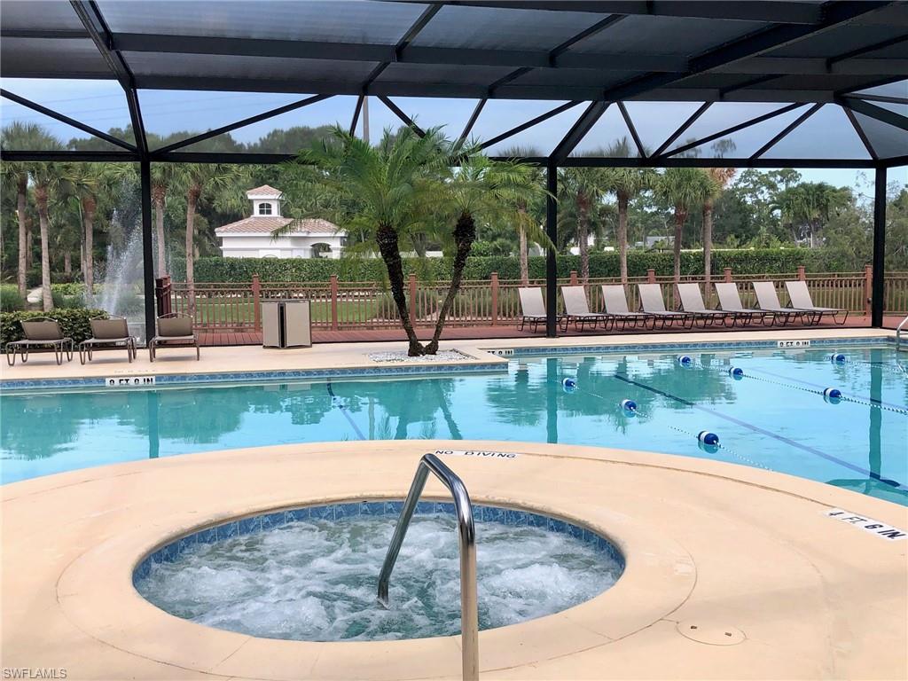 6879 Redbay Park Road, Unit 203 Naples, FL 34109 - Photo 32 of 34 a view of a swimming pool with a patio