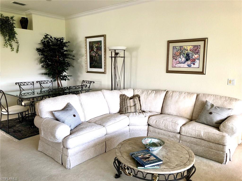 6879 Redbay Park Road, Unit 203 Naples, FL 34109 - Photo 10 of 34 a living room with furniture and a potted plant
