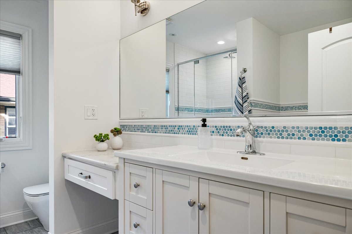 924 Chestnut Avenue Wilmette, IL 60091 - Photo 26 of 41 a bathroom with a sink and a mirror