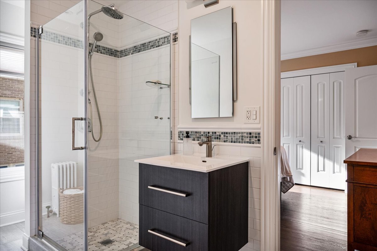 924 Chestnut Avenue Wilmette, IL 60091 - Photo 29 of 41 a bathroom with a sink a mirror and a shower
