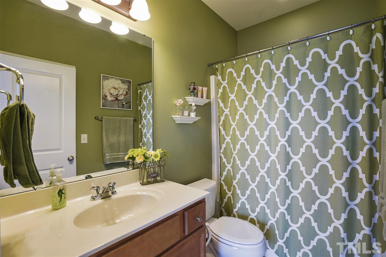 746 Wickham Ridge Road Apex, NC 27539 - Photo 15 of 22 a bathroom with a sink and a mirror