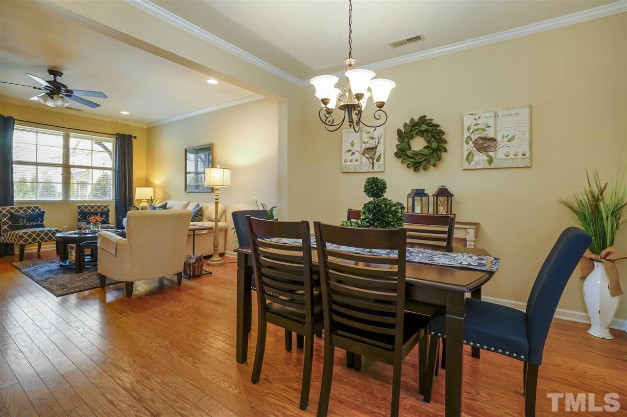 746 Wickham Ridge Road Apex, NC 27539 - Photo 7 of 22 a view of a dining room with furniture wooden floor and chandelier