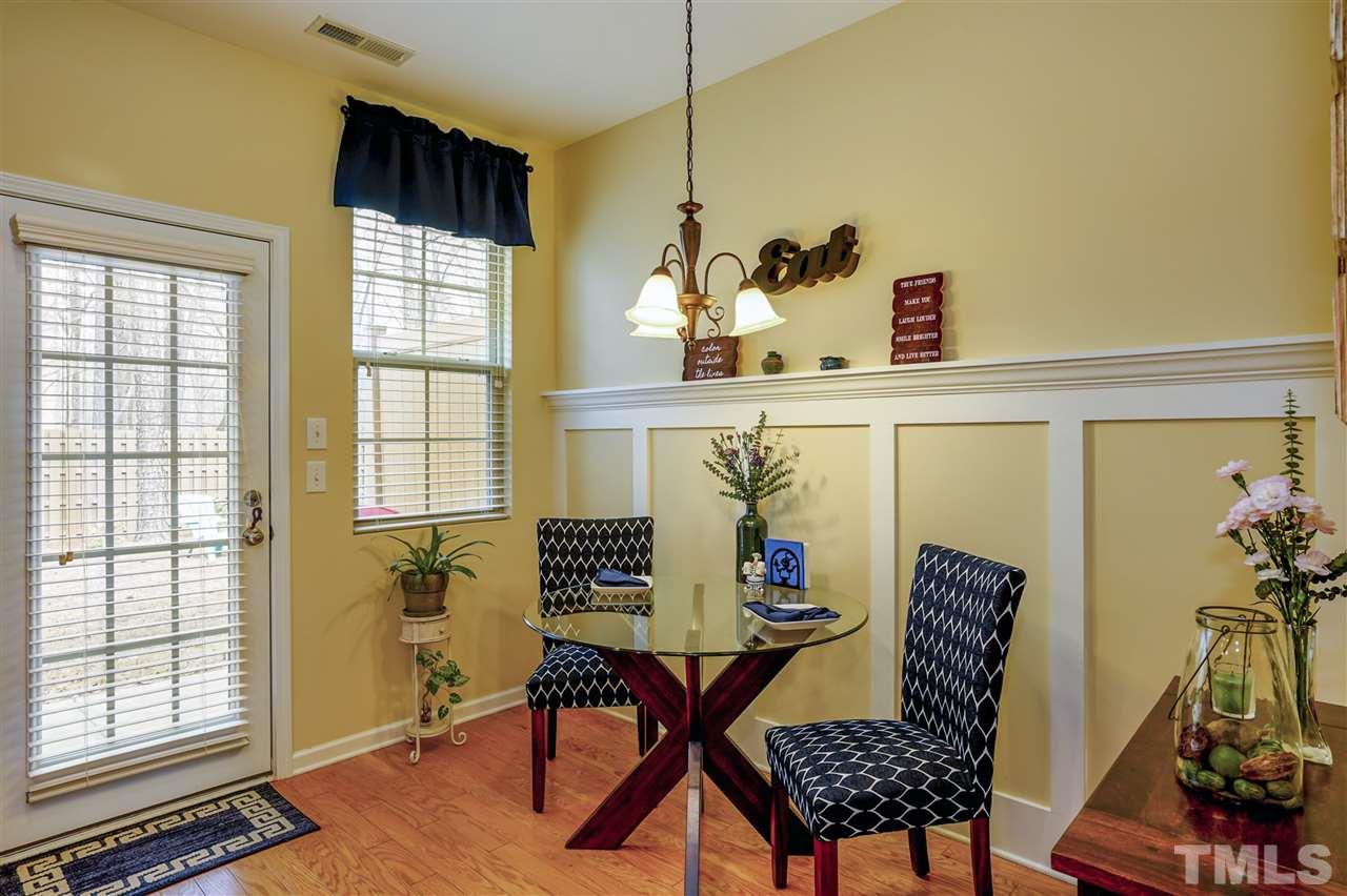 746 Wickham Ridge Road Apex, NC 27539 - Photo 9 of 22 a view of a dining room with furniture and a window