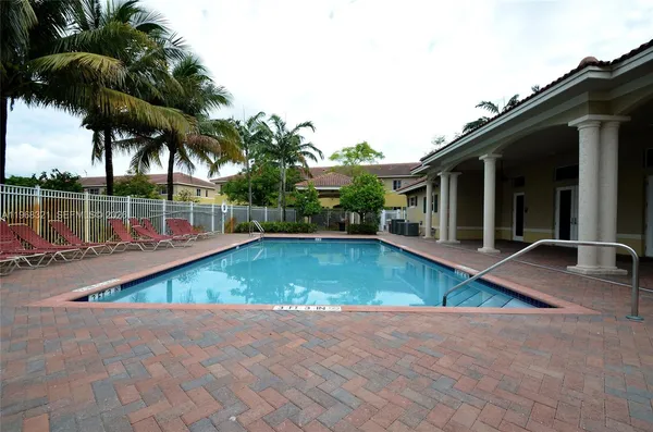 a view of a backyard with swimming pool