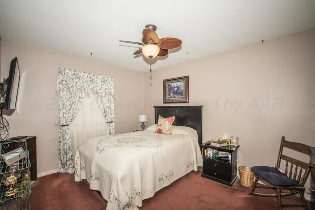 a bedroom with a bed and a chair