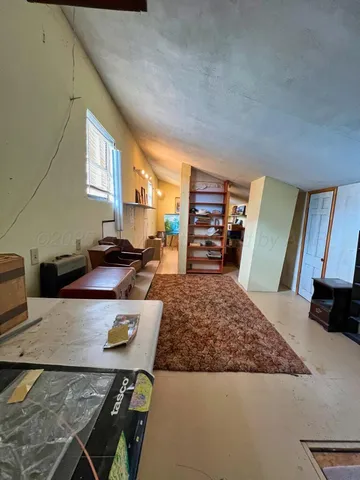 a view of a house with backyard porch and sitting area