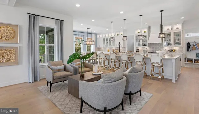 a living room with lots of furniture and a large window