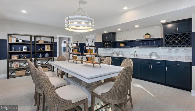 a large kitchen with a table and chairs