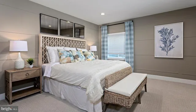 a bedroom with a bed and a lamp on table