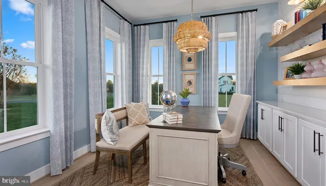 a view of a dining room with furniture and a window