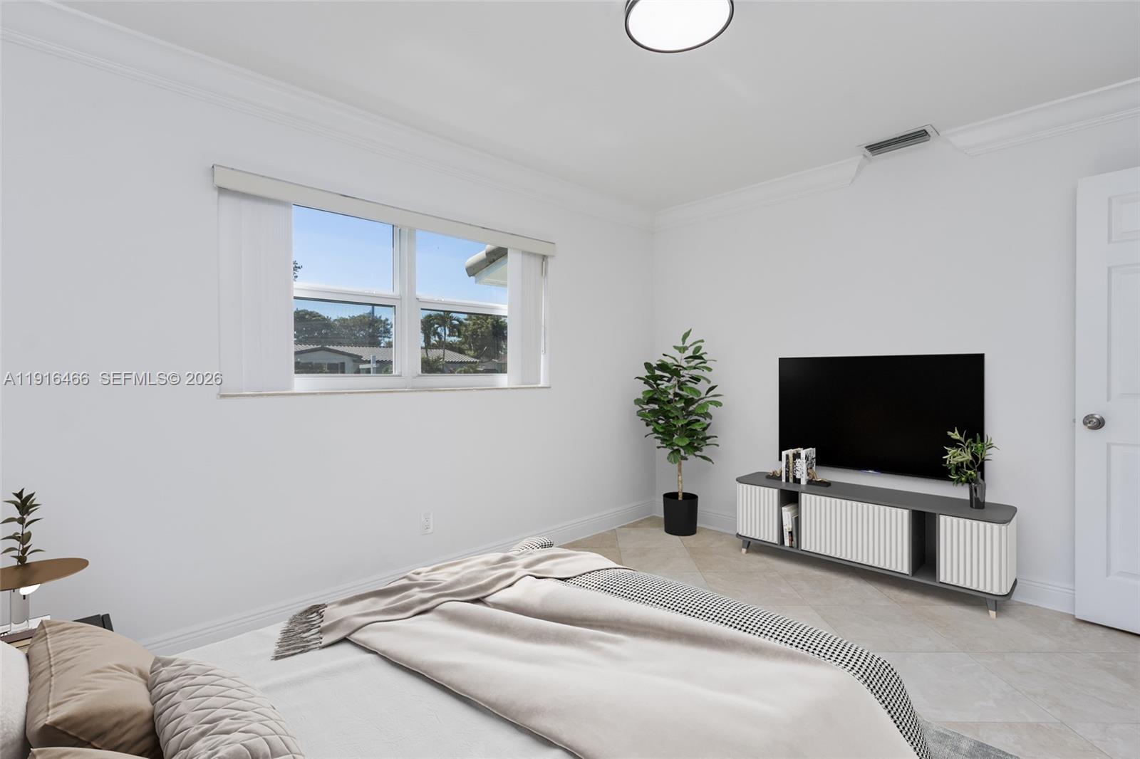 5425 Madison Street Hollywood, FL 33021 - Photo 18 of 45 a bedroom with a bed tv and a window