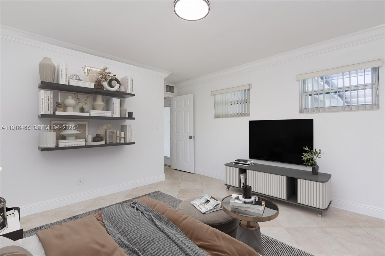 5425 Madison Street Hollywood, FL 33021 - Photo 21 of 45 a living room with a couch and a flat screen tv