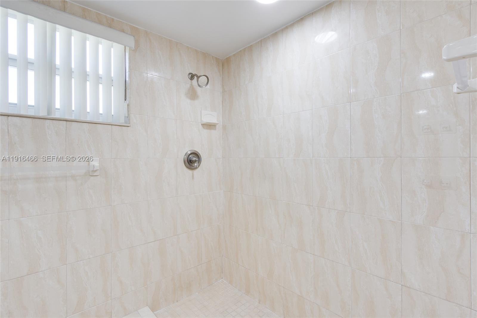 5425 Madison Street Hollywood, FL 33021 - Photo 25 of 45 a bathroom with a shower curtain