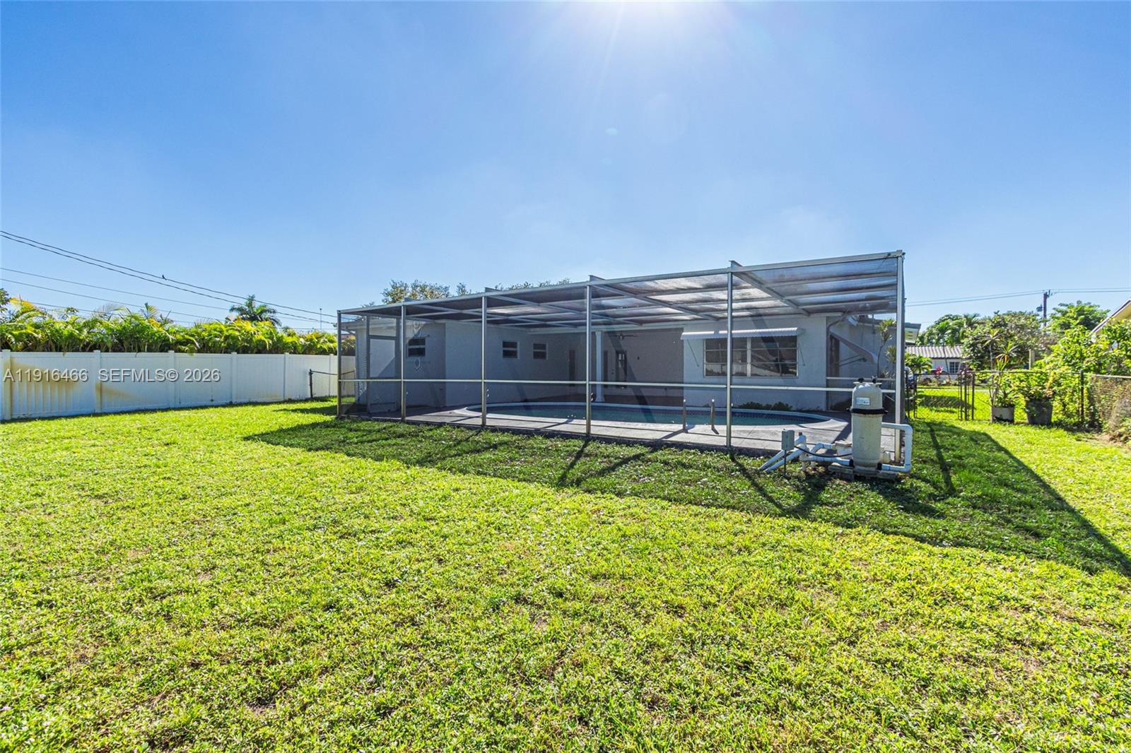 5425 Madison Street Hollywood, FL 33021 - Photo 31 of 45 a view of a house with a big yard and sitting area