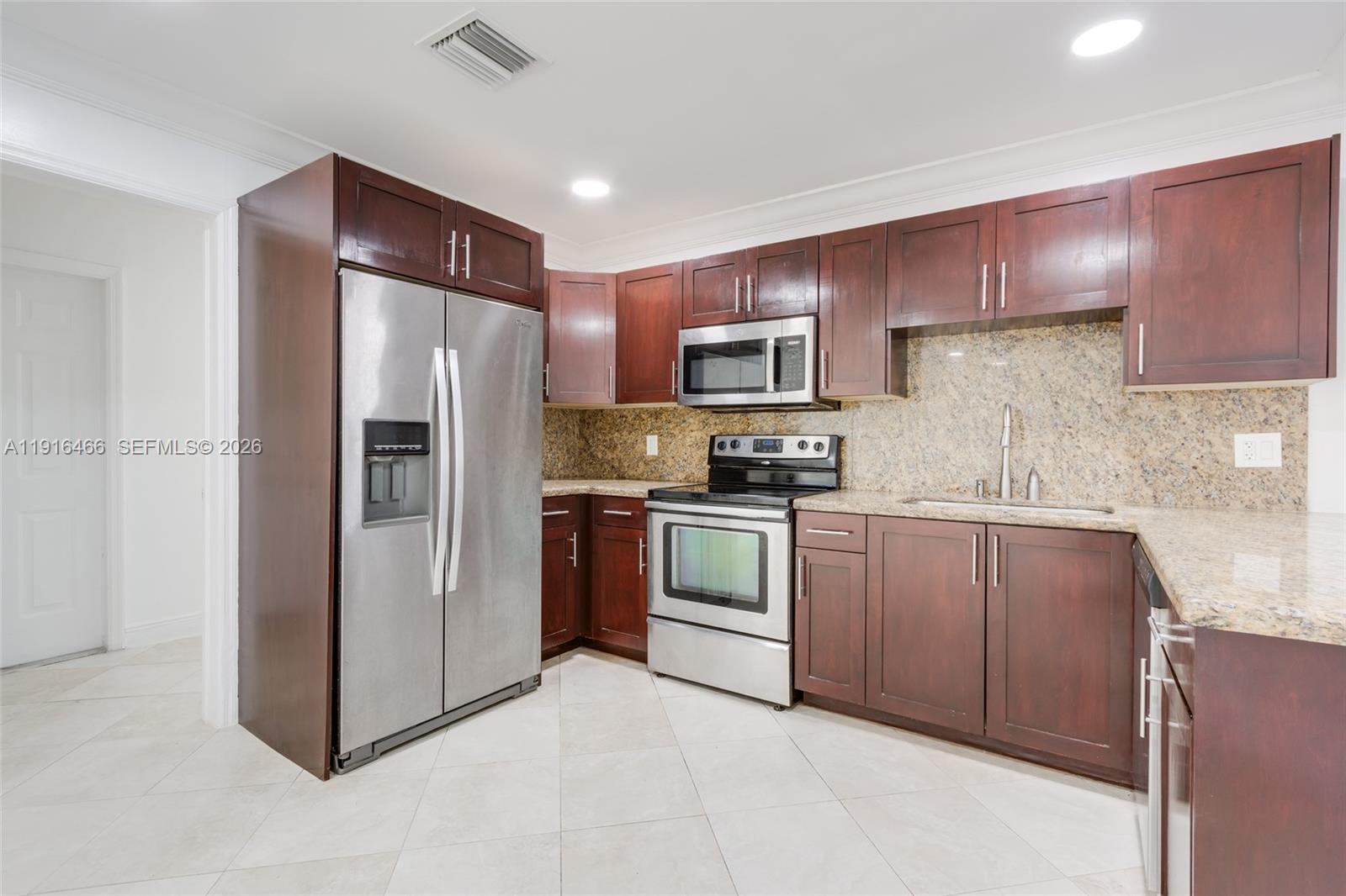 5425 Madison Street Hollywood, FL 33021 - Photo 9 of 45 a kitchen with a refrigerator sink and microwave