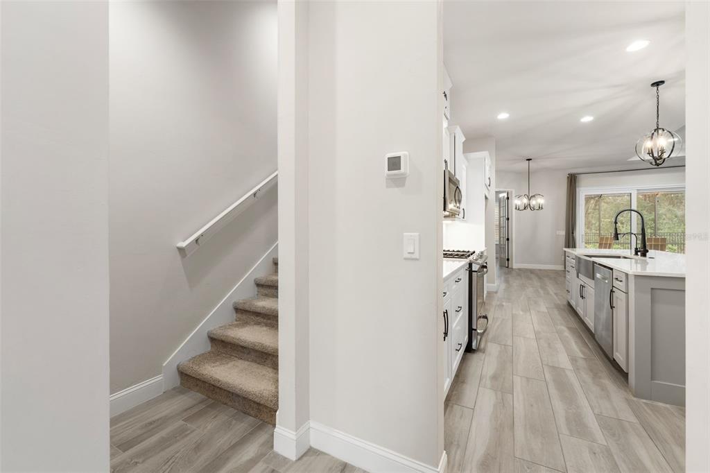 11081 Southwest 38th Boulevard Gainesville, FL 32608 - Photo 13 of 66 a view of a kitchen with cabinets and wooden floor