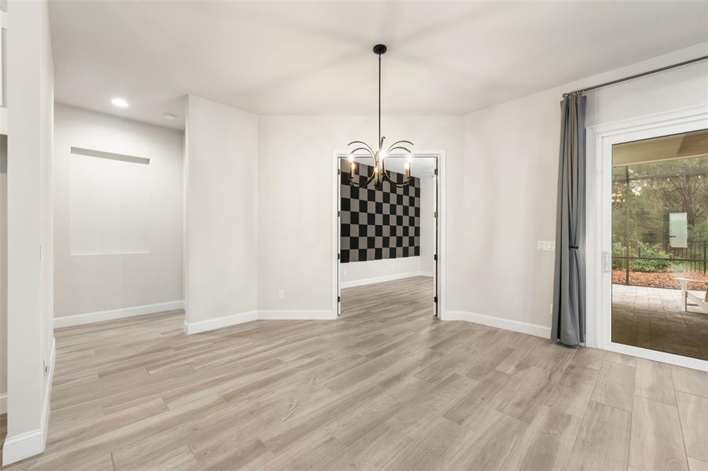 11081 Southwest 38th Boulevard Gainesville, FL 32608 - Photo 17 of 66 a view of empty room with wooden floor