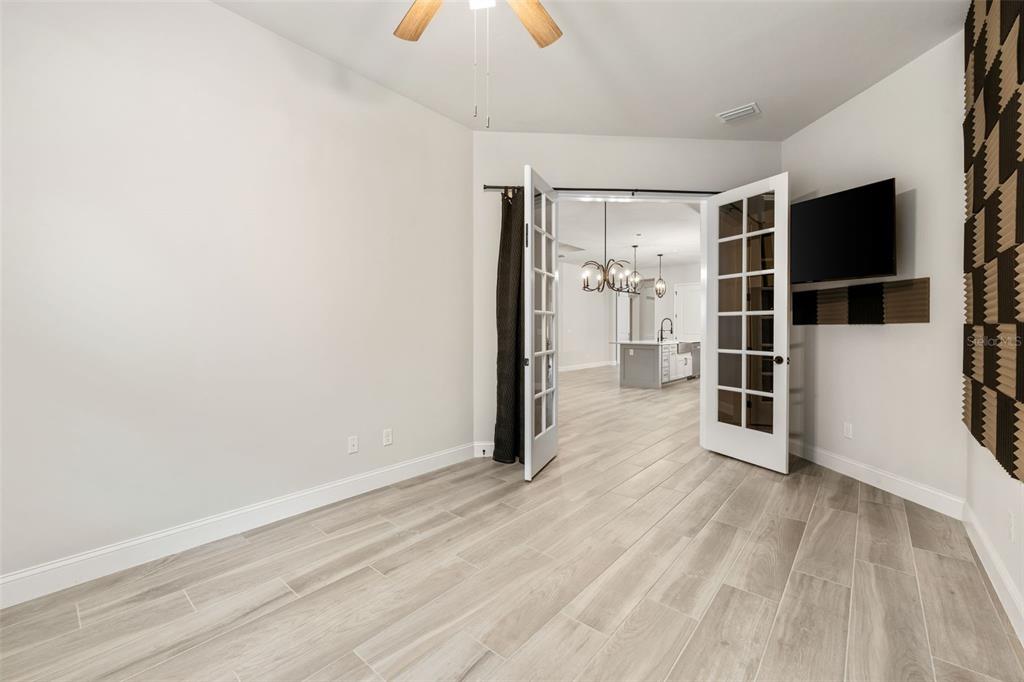 11081 Southwest 38th Boulevard Gainesville, FL 32608 - Photo 20 of 66 a view of empty room with wooden floor and window