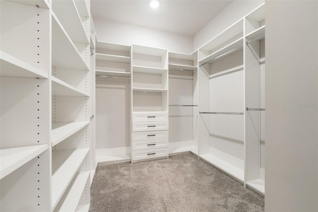 11081 Southwest 38th Boulevard Gainesville, FL 32608 - Photo 27 of 66 a view of walk in closet with empty racks