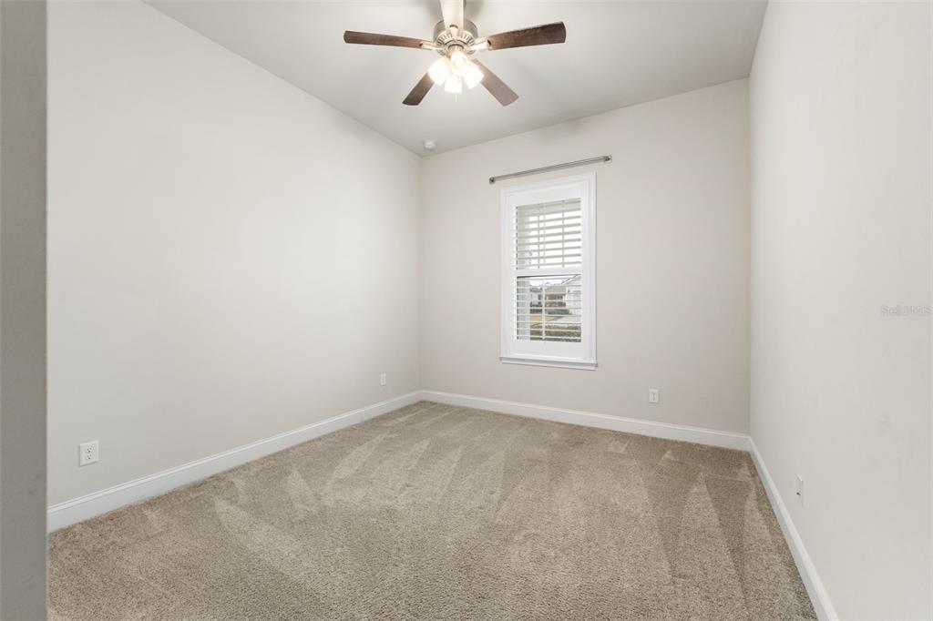11081 Southwest 38th Boulevard Gainesville, FL 32608 - Photo 29 of 66 an empty room with a window and a fan