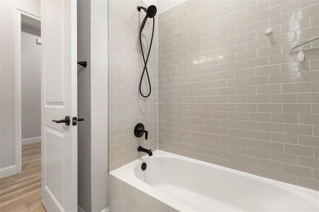 11081 Southwest 38th Boulevard Gainesville, FL 32608 - Photo 33 of 66 a bathroom with a shower and a bathtub