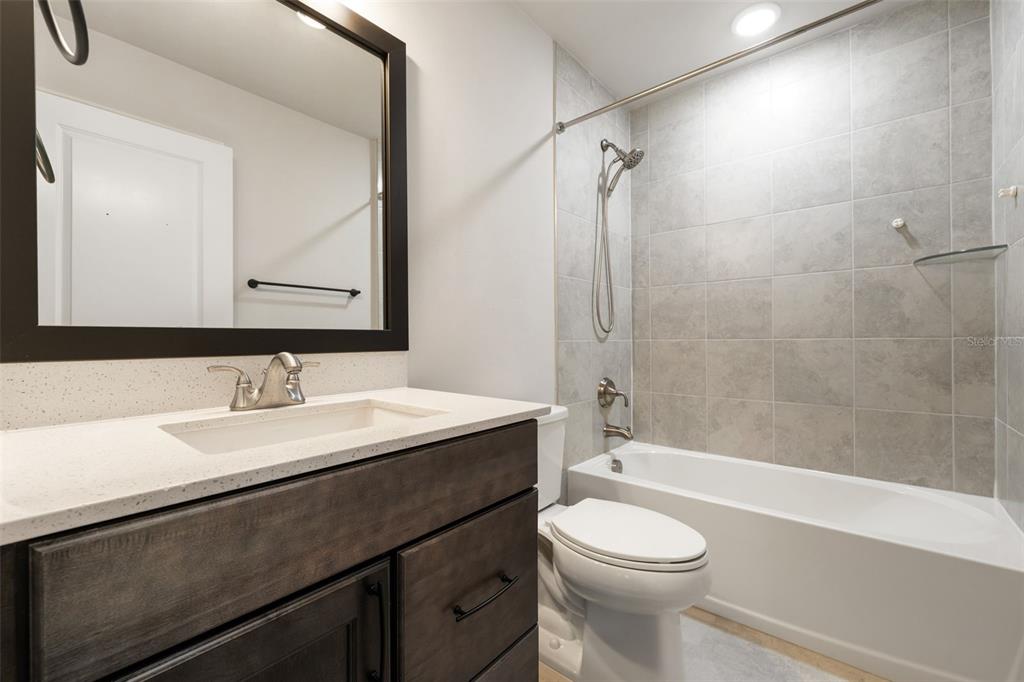 11081 Southwest 38th Boulevard Gainesville, FL 32608 - Photo 34 of 66 a bathroom with a sink a toilet and a mirror