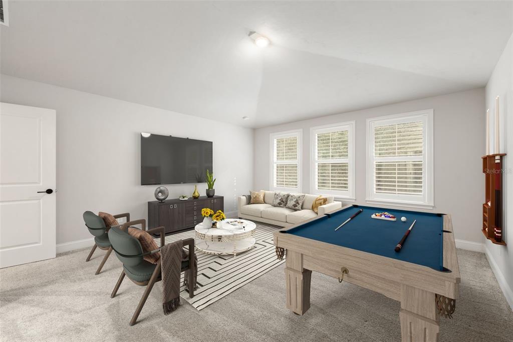 11081 Southwest 38th Boulevard Gainesville, FL 32608 - Photo 36 of 66 a living room with furniture and a flat screen tv