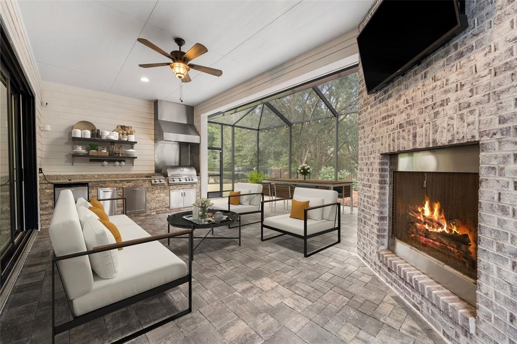 11081 Southwest 38th Boulevard Gainesville, FL 32608 - Photo 41 of 66 a living room with furniture a fireplace and a flat screen tv