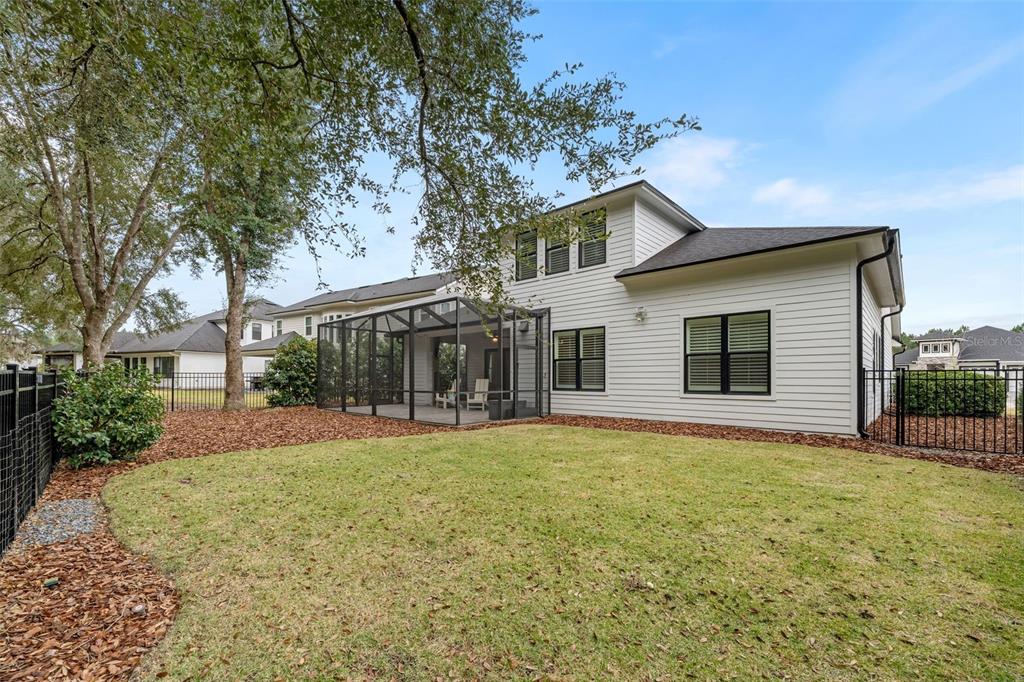 11081 Southwest 38th Boulevard Gainesville, FL 32608 - Photo 46 of 66 a view of a house with a yard and pathway