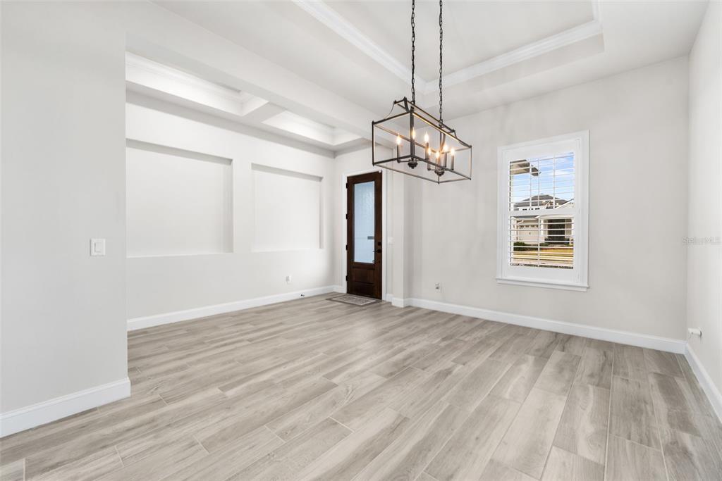 11081 Southwest 38th Boulevard Gainesville, FL 32608 - Photo 7 of 66 a view of empty room with wooden floor and ceiling fan