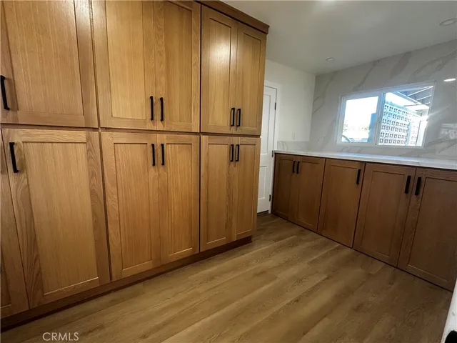 a view of a storage & utility room with two washing machine