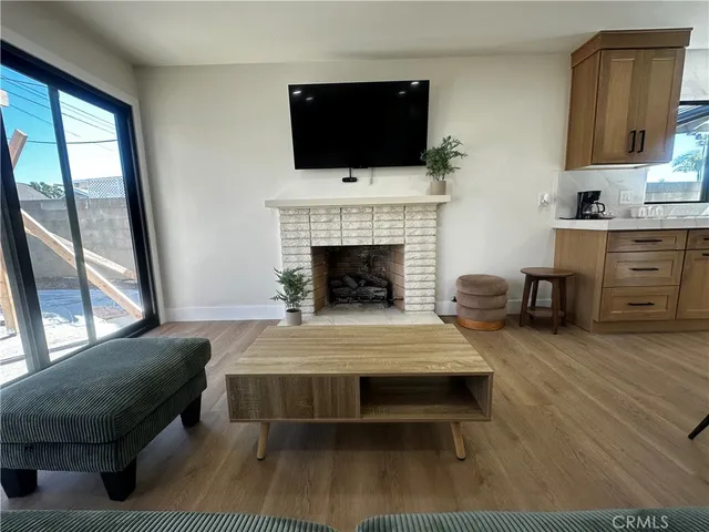 a living room with furniture fireplace and window