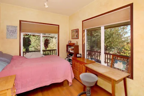 a kitchen with stainless steel appliances kitchen island granite countertop a table chairs in it and a window