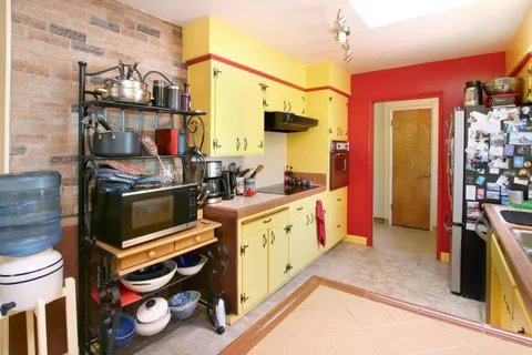 a view of a patio with table and chairs and potted plants