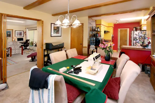 a view of backyard with a table and chair with wooden fence