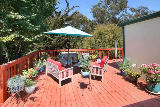 a backyard of a house with a garden and outdoor seating