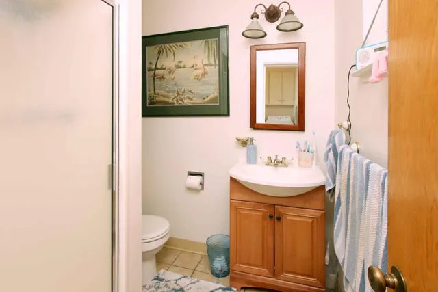 a palm tree sitting in front of a house with a yard