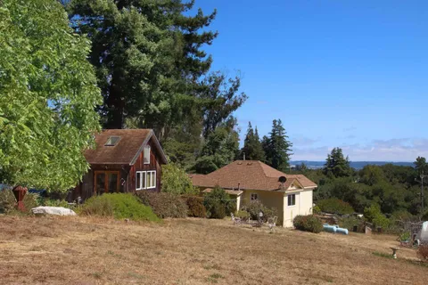 a front view of a house with swimming pool and glass windows