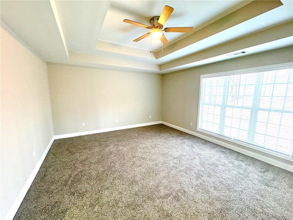 41 Oakmont Drive Southwest Rome, GA 30161 - Photo 12 of 21 an empty room with a ceiling fan and window