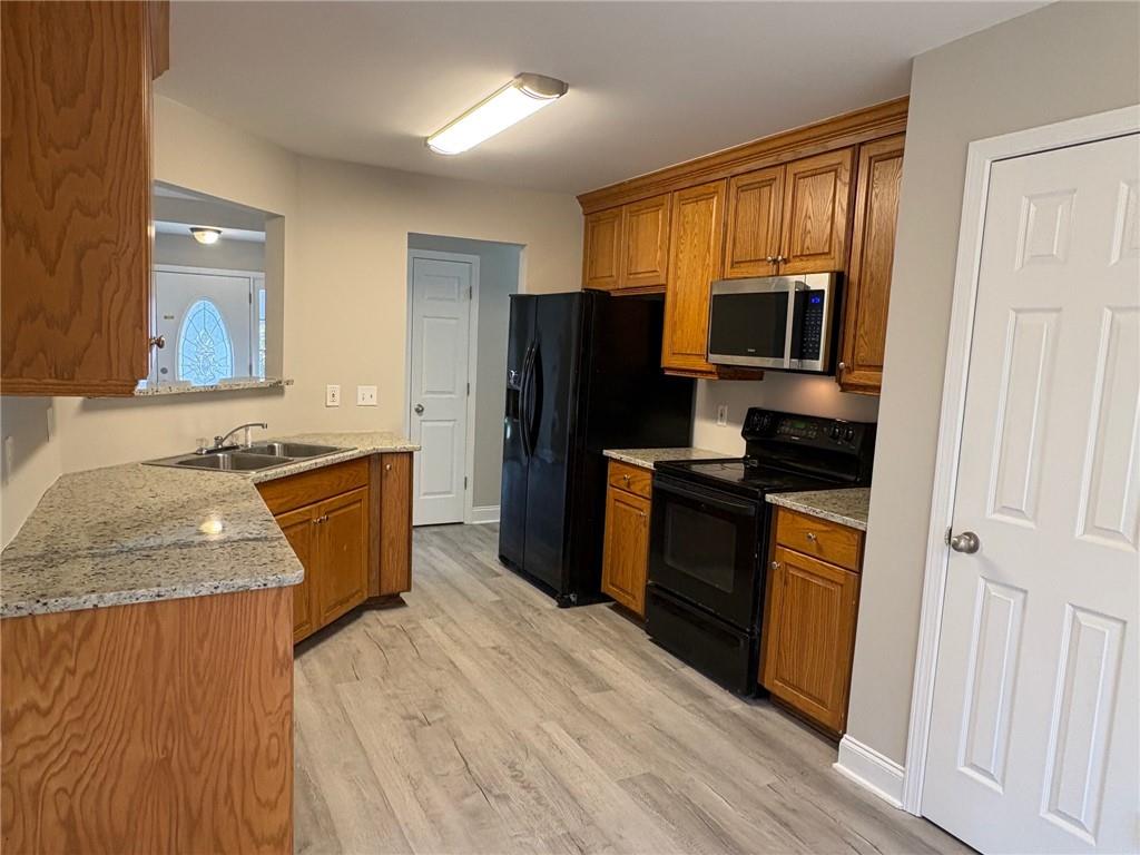 41 Oakmont Drive Southwest Rome, GA 30161 - Photo 8 of 21 a kitchen with granite countertop a refrigerator and a sink