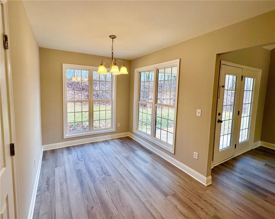 41 Oakmont Drive Southwest Rome, GA 30161 - Photo 9 of 21 a view of an empty room with wooden floor and a window
