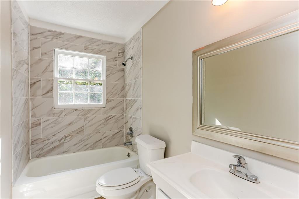 4179 Williamson Road Ellenwood, GA 30294 - Photo 13 of 25 a bathroom with a sink toilet and shower